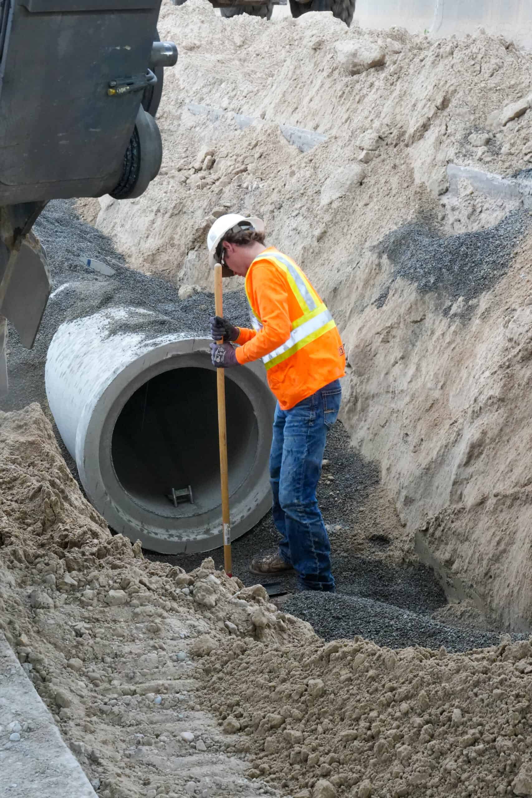 Man working in trench.