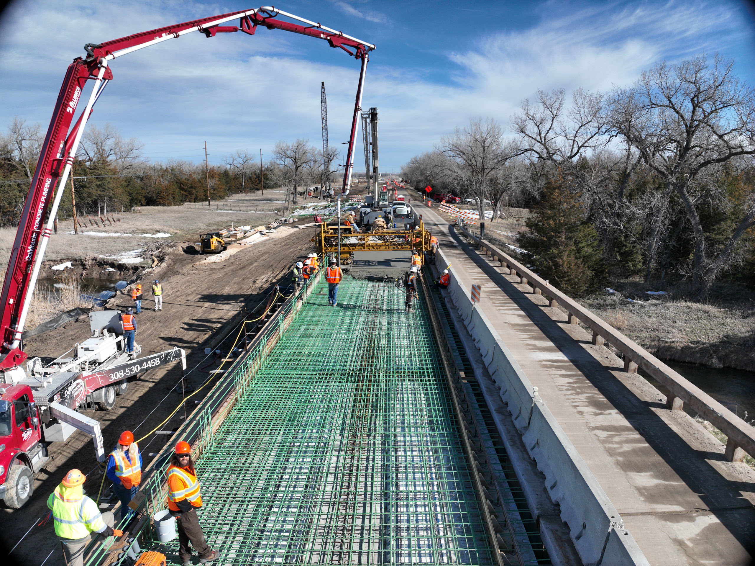 Construction site featuring workers and machinery on a bridge