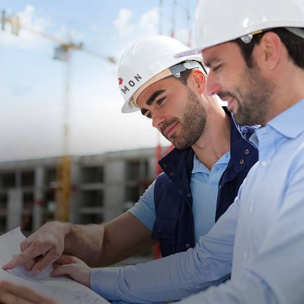 Two men in hard hats on a job site